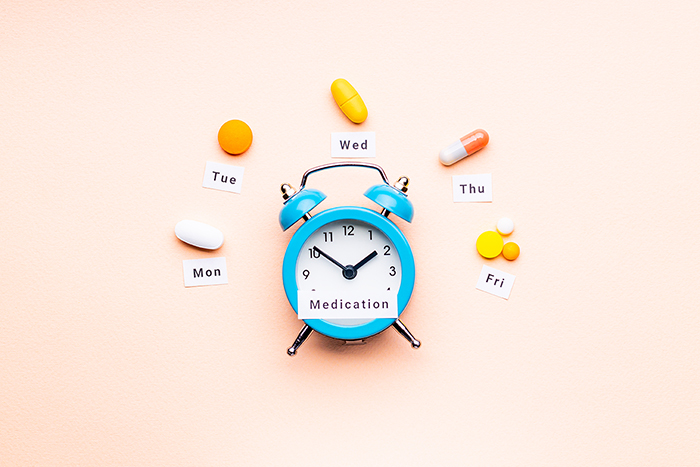 Blue Clock Surrounded By Medicine